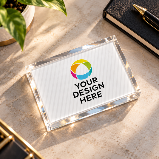 Custom acrylic paper weight measuring 7.62 cm by 5.08 cm with personalized logo design on a luxury wooden desk