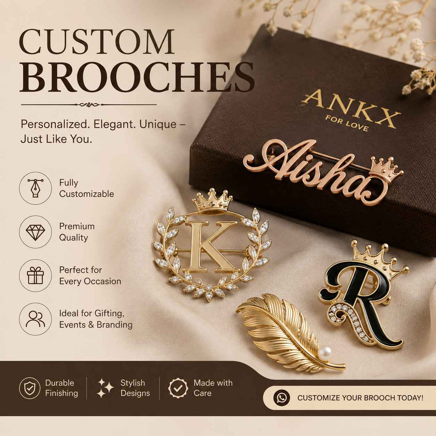 ankxbulk premium custom brooches featuring personalized names, initials, and elegant gold designs displayed on satin fabric with ANKX gift packaging.