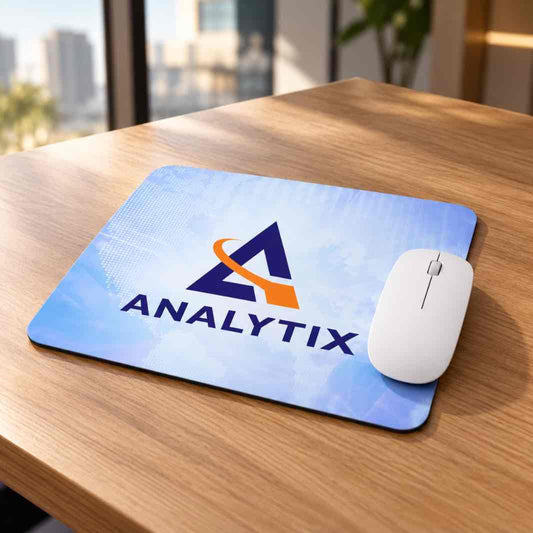Analytix branded mouse pad with white wireless mouse on a premium wooden office desk
