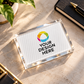 Custom acrylic paper weight measuring 7.62 cm by 5.08 cm with personalized logo design on a luxury wooden desk