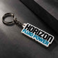 White Horizon Fluid Power personalized keychain with silver metal ring displayed diagonally on a dark textured surface