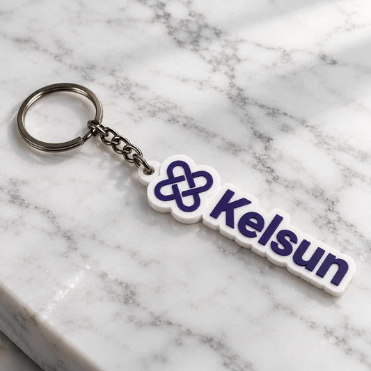 White Kelsun acrylic keychain with purple logo and lettering placed diagonally on white marble surface. 