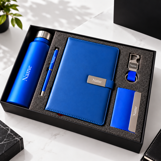 Personalized blue corporate gift set featuring a bottle, pen, leatherette diary, keychain and cardholder in a black presentation box.