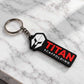 personalized keychain featuring a white helmet logo, red TITAN lettering, white SCAFFOLDING text, silver chain and keyring on white marble.
