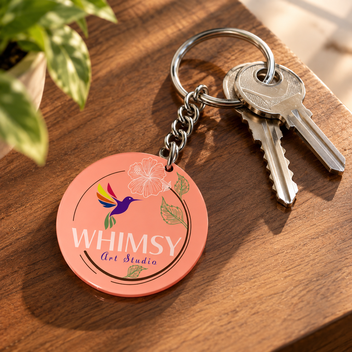 Pink floral personalized acrylic keychain with dark green panel, thank you message, silver chain and keyring on a white marble surface