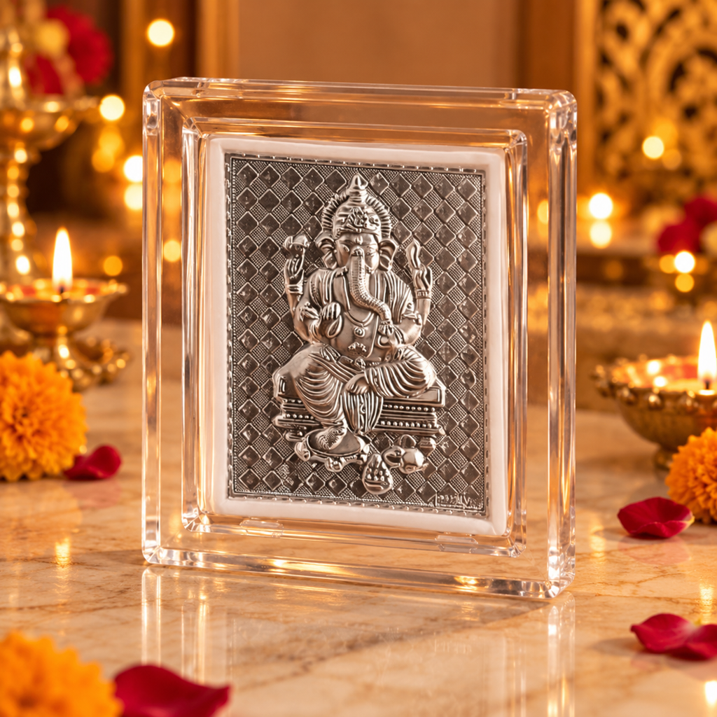 Silver Lord Ganesha relief frame displayed on a dark wooden surface with diyas and warm golden festive lights