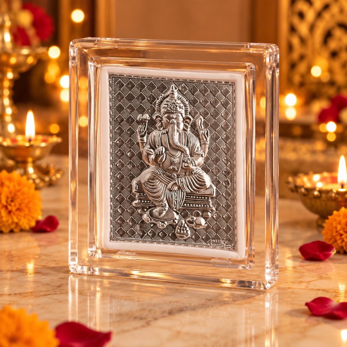Silver Lord Ganesha relief frame displayed on a dark wooden surface with diyas and warm golden festive lights