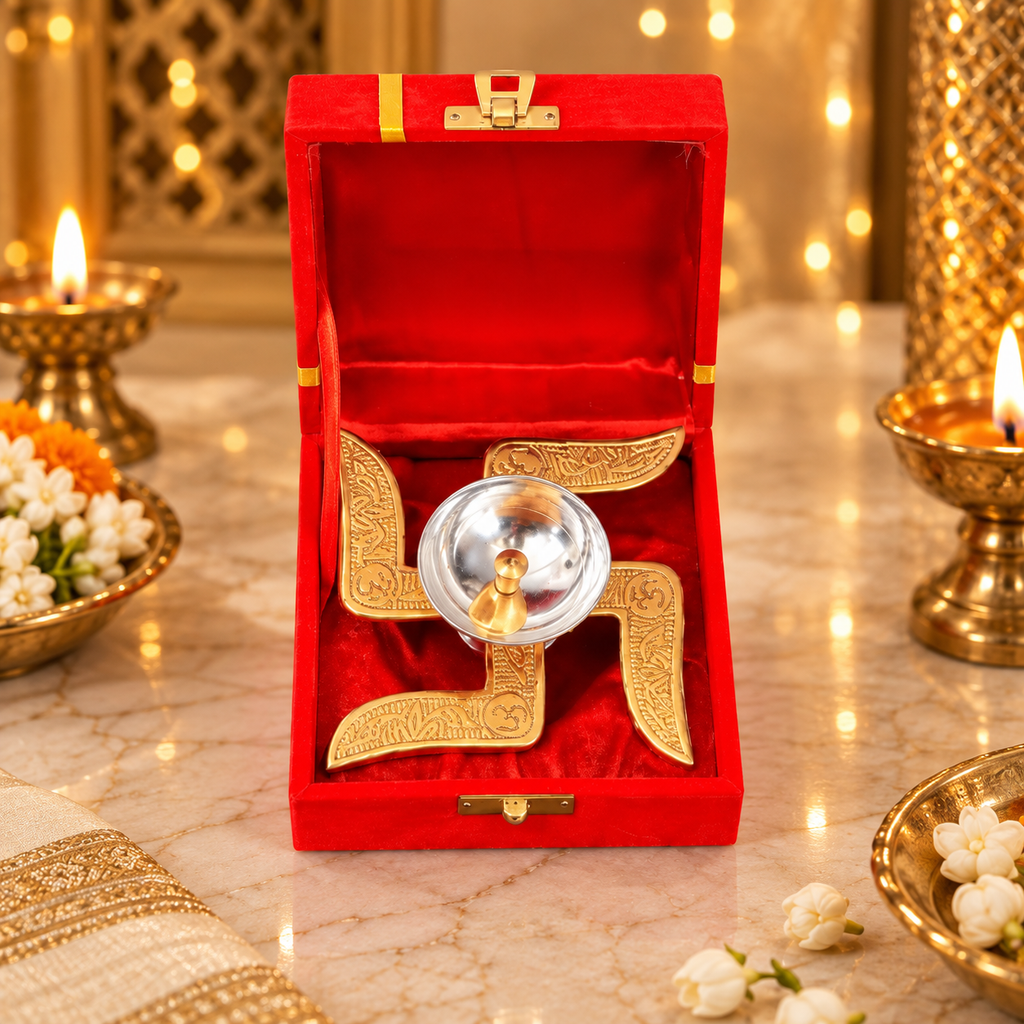 Swastik Diya in a red velvet presentation box displayed on a marble surface with warm festive lighting and traditional décor.