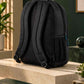 Black custom logo backpack photographed from a rear-left angle with lime green and purple geometric styling