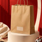 Brown kraft paper carry bag displayed on a cream pedestal against a cherry red fashion-inspired backdrop