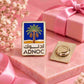 Personalized ADnoc logo lapel pin styled with a pink gift box, soft floral details and a feminine premium gifting theme.