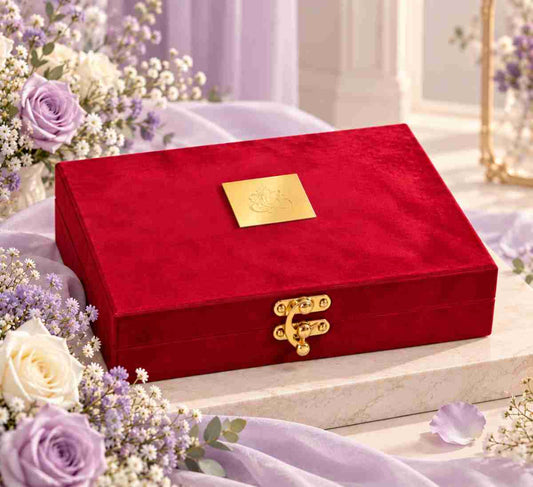 ANKX red velvet jewellery box with gold hook and plaque styled on a cream pedestal with lavender flowers and soft ivory décor.
